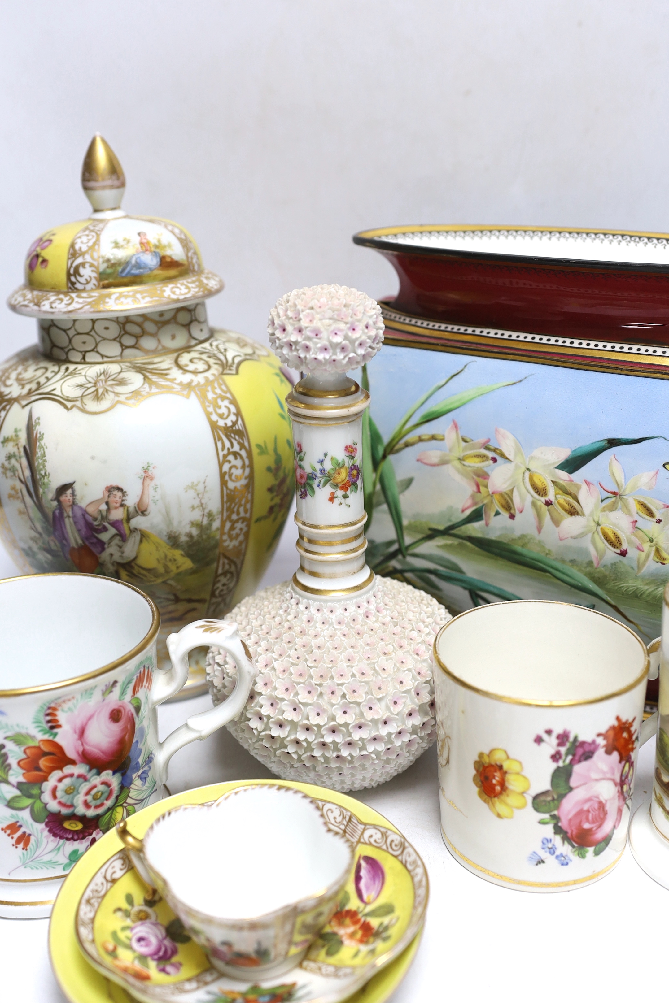 A Dresden jar and cover and similar cup and saucer, a large floral vase, two floral mugs, a floral encrusted bottle and stopper and two other items, largest 28cm high (8)